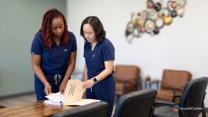 A board-certified gastroenterologist and a clinical nurse collaborating over a long-term care plan for chronic IBS flare up management in Pearland.