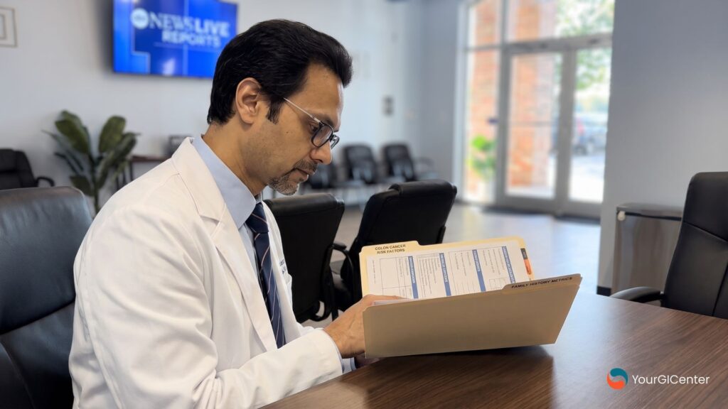 A professional gastroenterologist evaluating a physical family history medical chart to analyze patient eligibility for colon cancer screening in Houston.