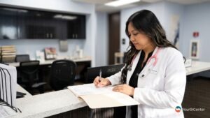 A first-time patient reviewing comprehensive diagnostic intake forms during a primary medical checkup conducted by a top gastroenterologist pearland tx and a dedicated gi specialist pearland.