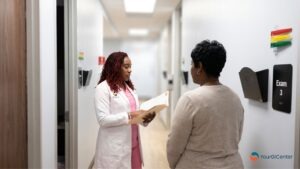 A supportive clinical nurse explaining diverticulosis prevention timelines to a patient during a consultation with a top gi doctor pearland provider from the best gastroenterologist pearland directory list.