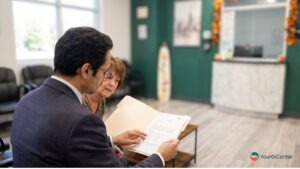 An IBD specialist Houston TX reviews patient history during a consultation evaluating chronic Crohn's disease symptoms at Your GI Center